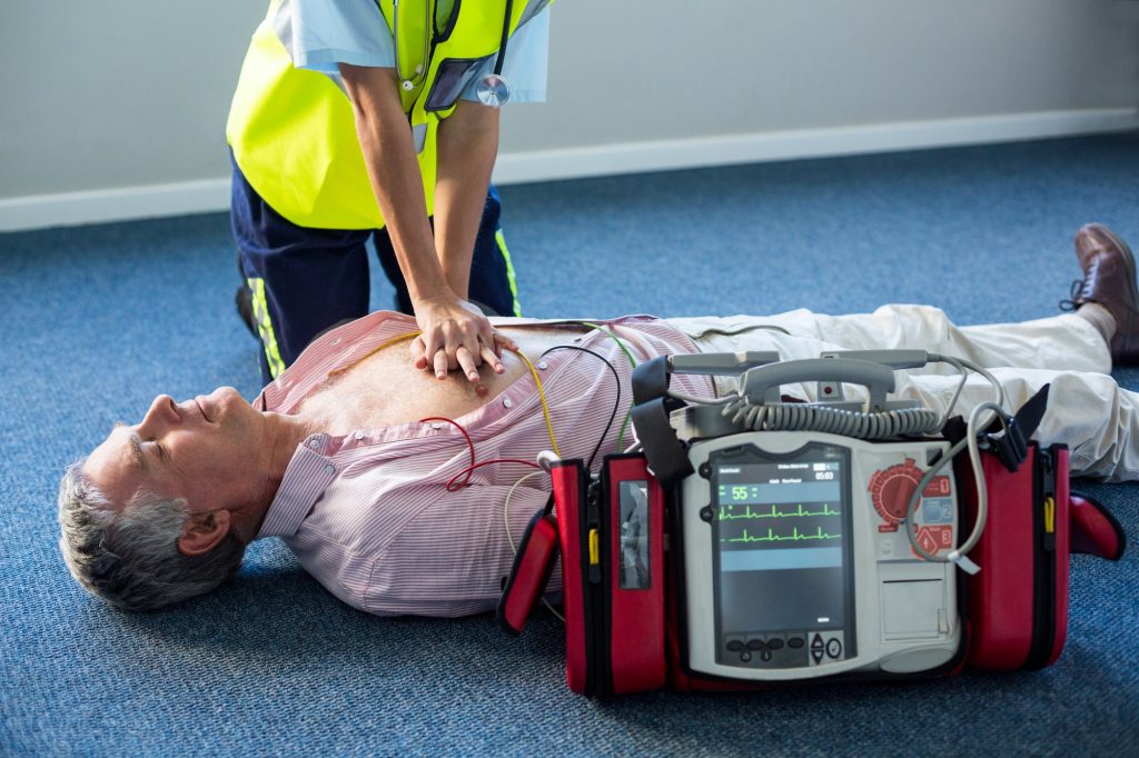 Paramedic using an external defibrillator during cardiopulmonary resuscitation
